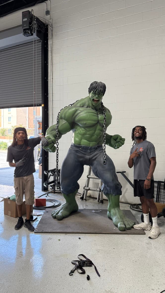 Crew members with an oversized Hulk statue, moved as a specialty item
