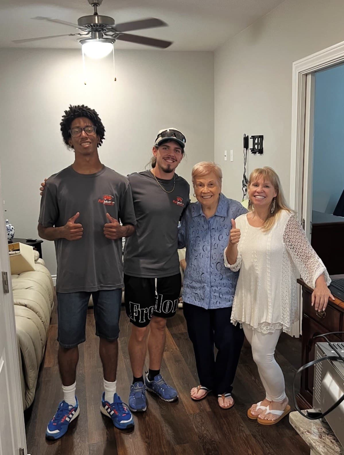 Full Motion crew members with a happy client after a senior relocation move