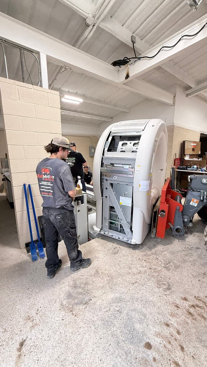 Full Motion Services crew servicing large equipment during a commercial move